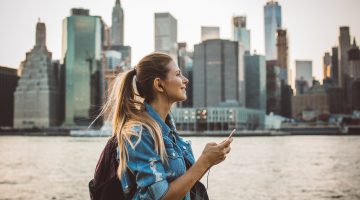 Young woman Exploring North America and using mobile data.