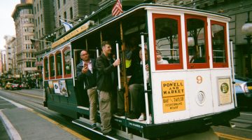 Man on a tram in San Francisco, using his mobile data